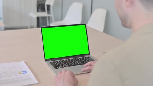 Businessman Using Laptop with Green Screen