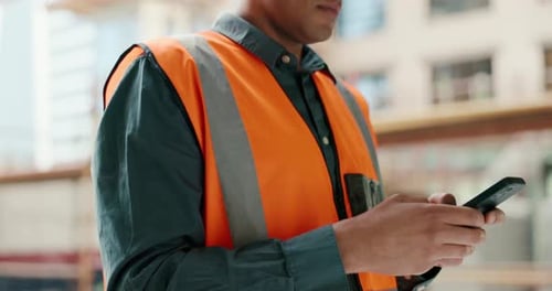 Smartphone, typing and construction worker communication for fast building development update