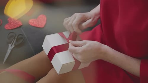Woman Tying Ribbon on Hexagonal Gift Box