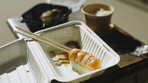 Shooing away flies food Sushi entree roll rice eel sashimi chopsticks 4K
