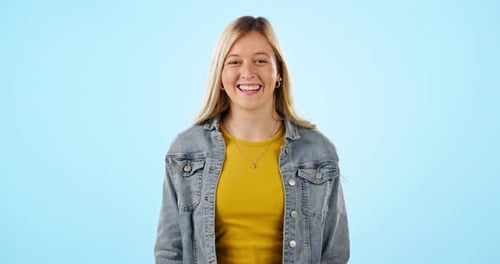 Young, woman and smile with happiness in studio on blue background for mockup