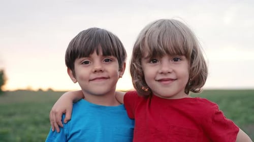 Portrait of Smiling Little 4 Years Old Boys on Green Meadow Nature Background