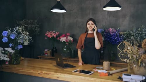 In a Charming Flower Shop a Skilled Florist Owner Showcases Her Talent and Enthusiasm While Taking