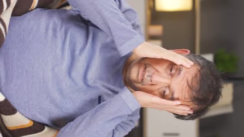 Man Sits, Suffering from Headache and Chest Pain