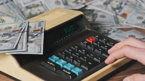 Calculator Calculating Numbers with Surrounding Cash