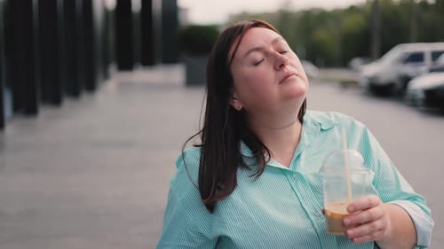 Woman Enjoys Coffee on a Cloudy Day