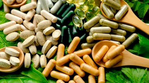 Vitamin Capsules and Tablets with Green Leaves