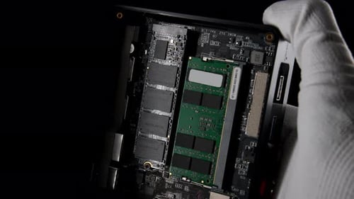 Inside Out Mini Computer Disassembly Revealing Memory Slots and SSD