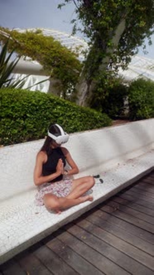 Woman Using VR Headset in Urban Park Setting