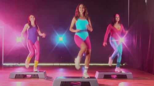 Fitness Instructor Leading Cardio Step Aerobics Workout in Retro Neon Studio