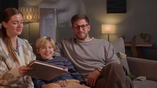 Loving Family Reading Photo Album on Couch