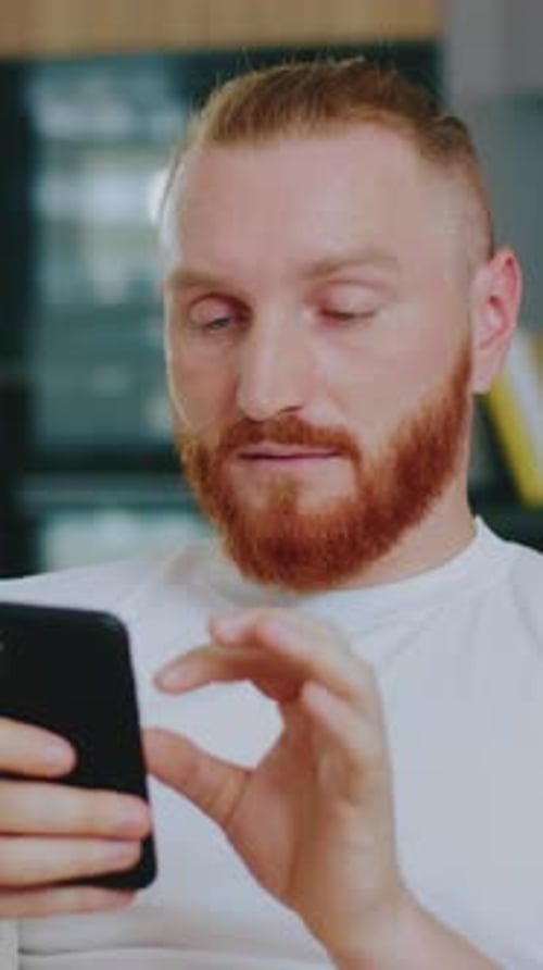 Young Adult Using Smartphone Indoors, Portrait