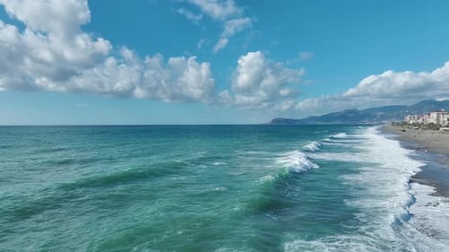 Aerial View of Blue Sea Meeting Sandy Beach
