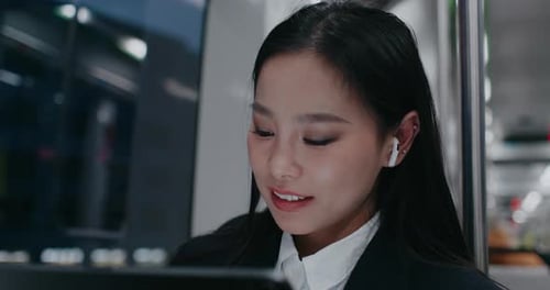 Portrait of Adorable Asian Woman in Black Jacket Wearing Earphones While Listening Music Busy Female