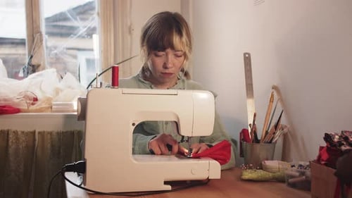 Woman Working at Sewing Machine in Studio