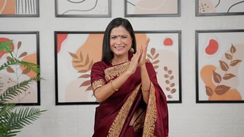 Woman in Sari Clapping Happily Indoors