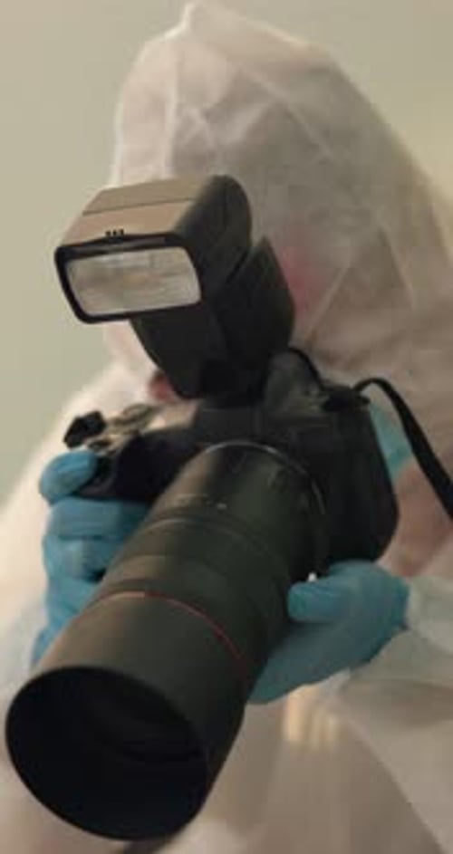 Photographer Wearing Hazmat Suit Holding Camera With Flash