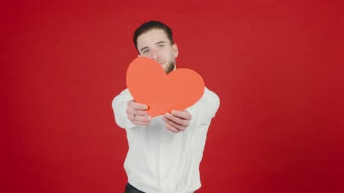 Young Adult Man Holding Large Red Heart