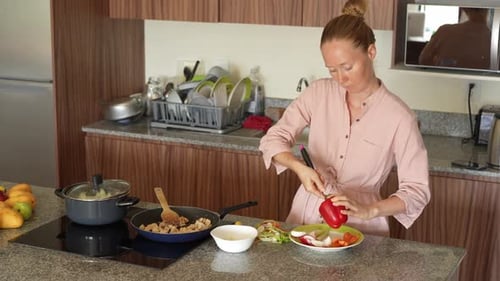 Woman Prepares Vegetables in a Modern Kitchen