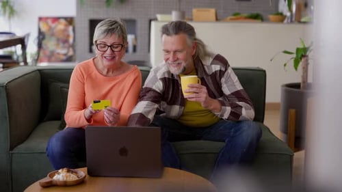 Couple Shopping Online at Home With Laptop