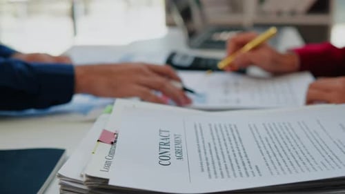 Reviewing Contract Paperwork in Bright Office Workplace