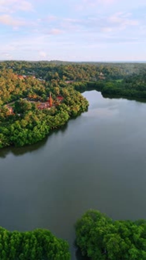 Beautiful lake and waterfronts with lush greenery. Houses located in the woods of Sri Lanka