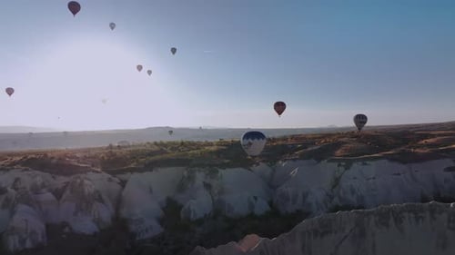 Hot Air Balloons Float Over Cappadocia Landscape