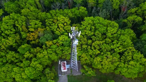 Orbital aerial of a communications tower in the middle of forest trees
