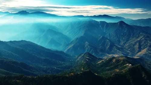 Mighty green mountains in California covered with blue mist. Splendid view of the rocks in blue haze