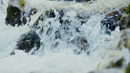 river water bouncing over stones in slow motion