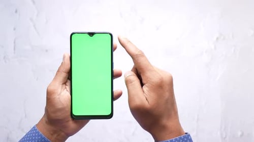 Close Up of Young Man Hand Using Smart Phone with Green Screen