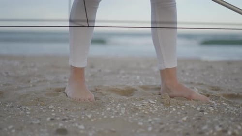 Feet of Unrecognizable Woman Standing Barefoot at the Beach