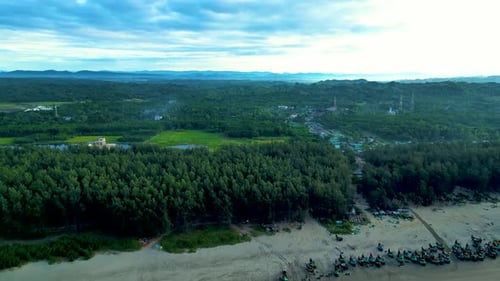 Aerial View of Seabeach with Trees, Fishing Boat, and a Fish Market Amidst Lush Greens