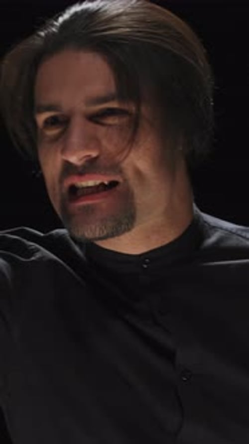 Man Singing Close-up Portrait on Black Backdrop