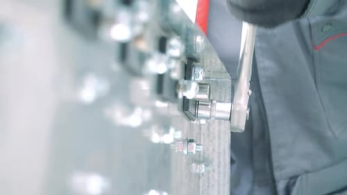 Technician Using Wrench to Tighten Nut and Bolt