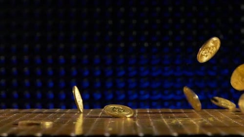 Bitcoin coins falling on a golden surface