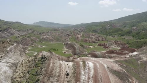 Aerial view over amazing colorful landscape of mineral stone rock formation terrain. Bright summer d