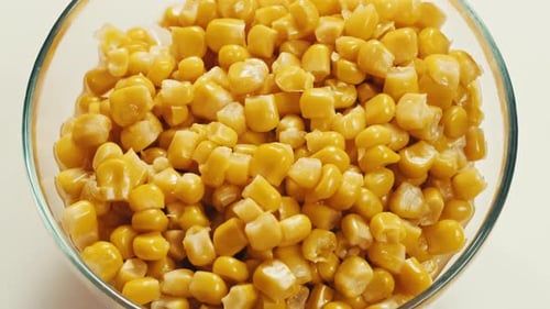 Canned Sweet Corn Macro Close Up Rotating on Dark Background Close Up on Opened Aluminum Can with