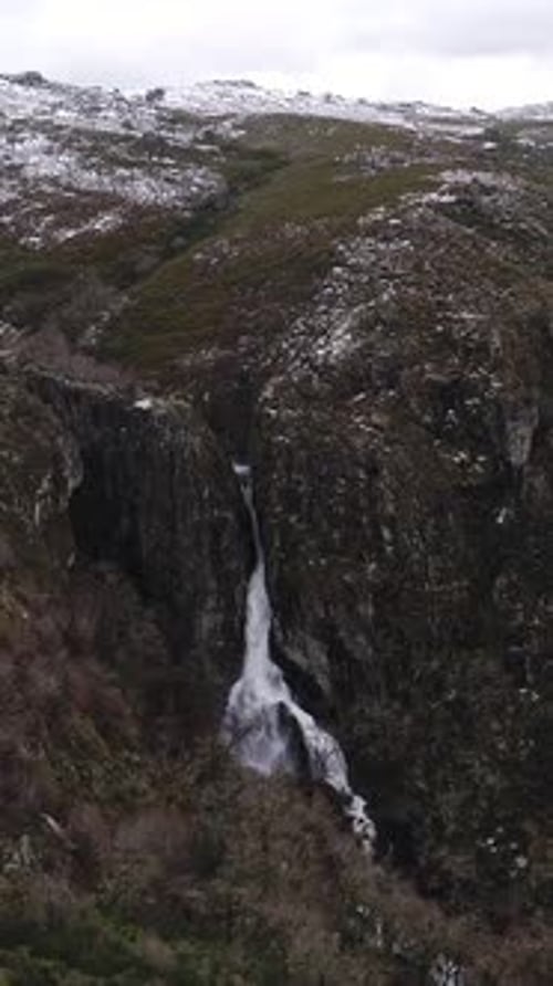 Majestic waterfall surging through cliffs in Portugal