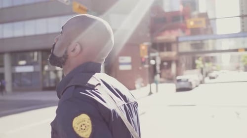 Of Sunray on Security Guard Walking in City Center