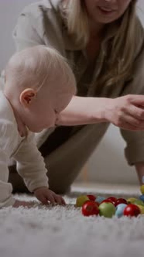 Baby Crawling on Carpet with Woman