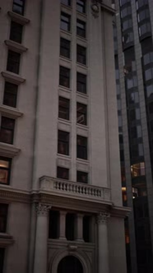 Historic Building Stands in Contrast to Modern Skyline in Evening Light