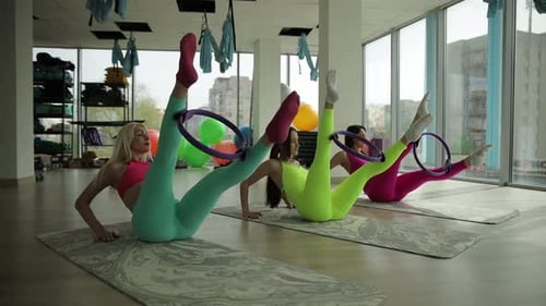 Women Doing Pilates Leg Exercise with Ring
