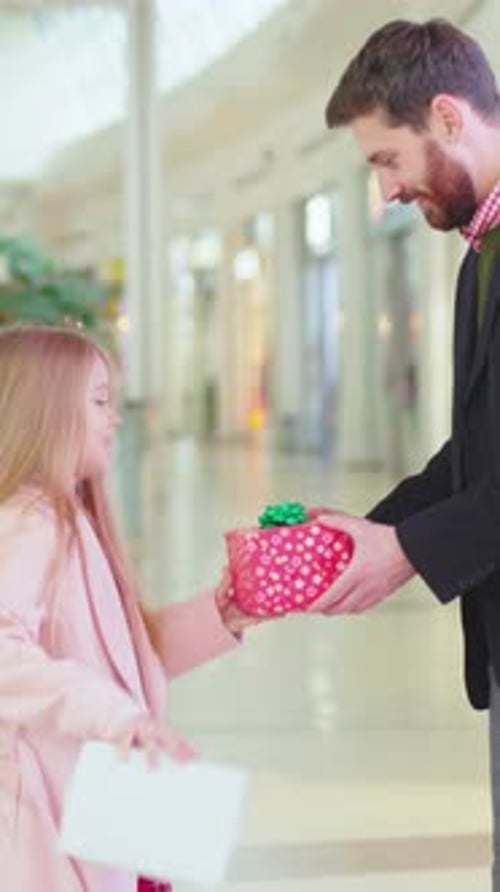 Father Giving Christmas Gift to Little Girl