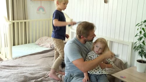 Loving Father Brushes Daughter's Hair at Home