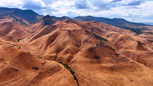 Aerial View of Dry Mountain Ridges and Winding River