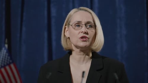Woman Speaking at Podium with American Flags