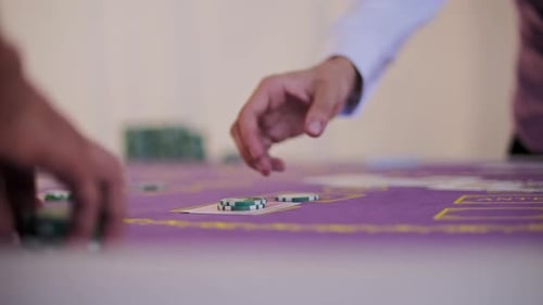 Hand Flipping Card on Casino Table