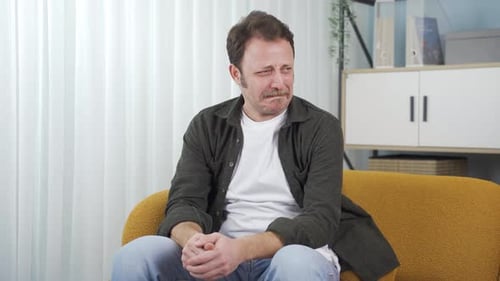 Sad man cries.