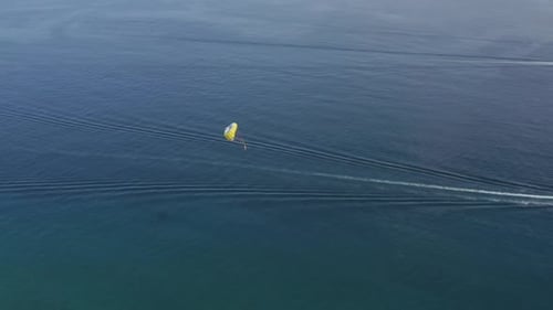 Aerial view of a person doing parasail in Sicily, Italy.